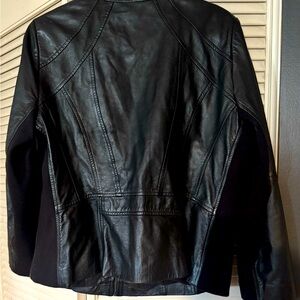 Fitted leather jacket w/ fabric side paneling.